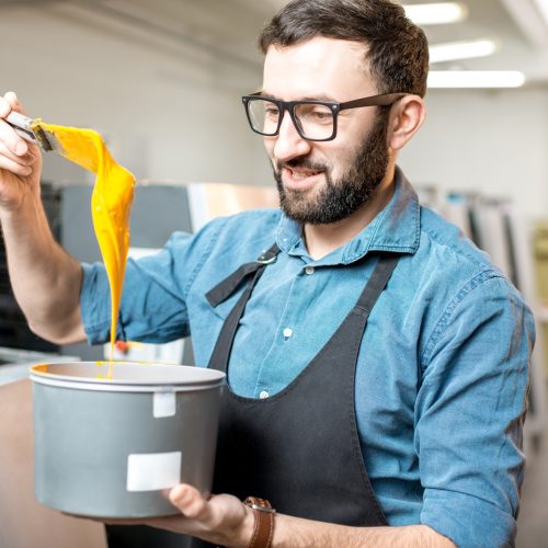 Typographer with paint at the manufacturing